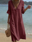 White linen V-neck loose maxi dress by FJØRNA, flowing and lightweight with a relaxed fit, perfect for casual summer wear.