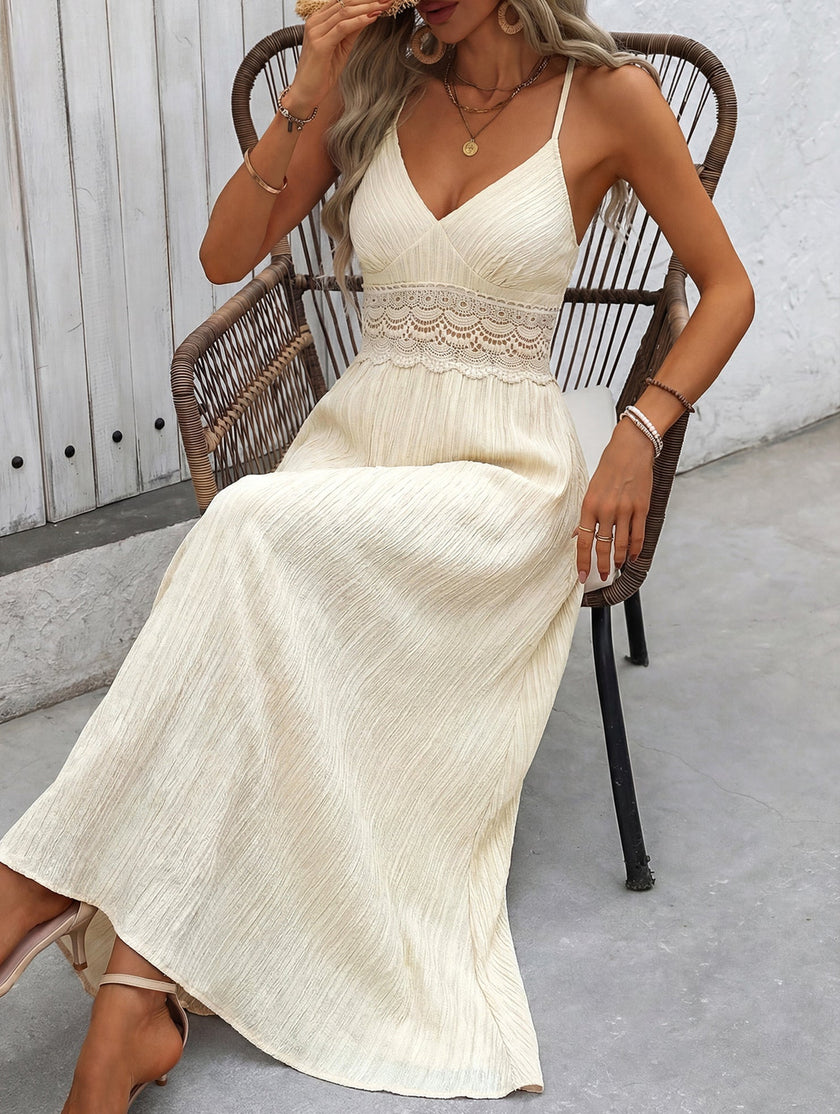 White FJØRNA halter lace patch V-neck maxi dress with flowing fabric and elegant design, perfect for summer occasions.
