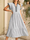 Black colorblock stripe flutter sleeve dress by FJØRNA, featuring a stylish design with contrasting white and black panels.