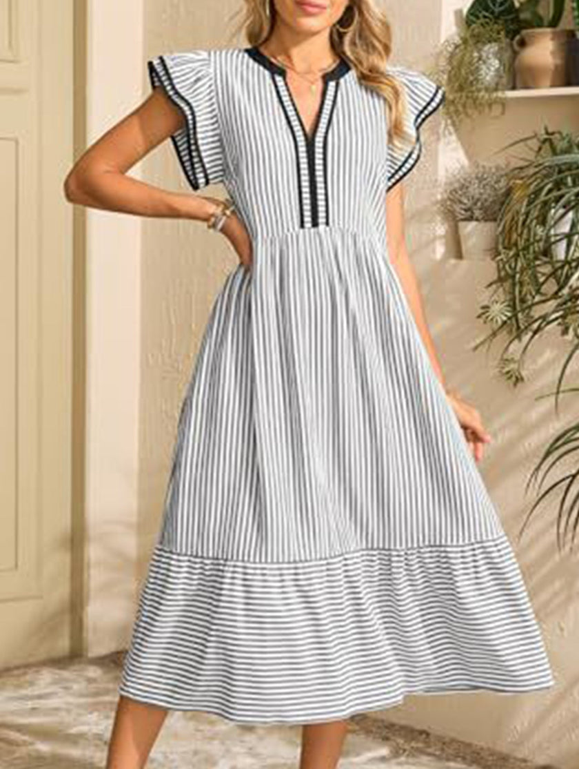 Black colorblock stripe flutter sleeve dress by FJØRNA, featuring a stylish design with contrasting white and black panels.