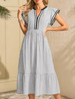 FJØRNA colorblock stripe flutter sleeve dress in white, featuring bold black accents and stylish design details.