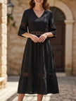 Black V-neck hollow short sleeve dress by FJØRNA, featuring a stylish design and lightweight fabric.