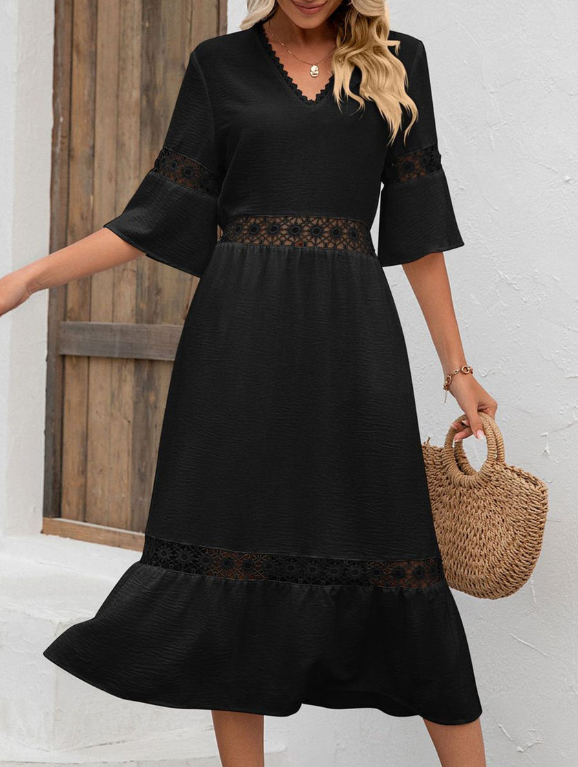 FJØRNA white V-neck hollow short sleeve dress displayed on a hanger, showcasing its elegant design and lightweight fabric.