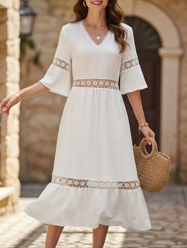 White V-neck hollow short sleeve dress by FJØRNA, featuring a stylish, flowy design with a fitted waist and elegant silhouette.