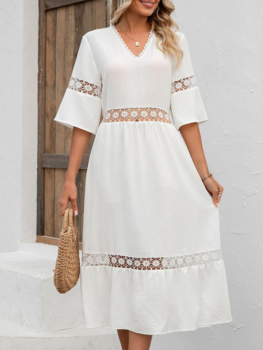 White V-neck hollow short sleeve dress by FJØRNA, showing a stylish, lightweight dress with a relaxed fit and subtle detailing.