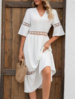 White V-neck hollow short sleeve dress by FJØRNA, lightweight and stylish for casual or summer wear.