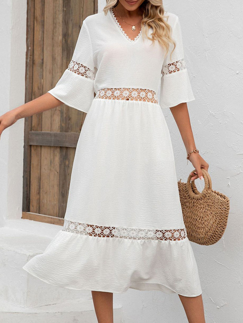 White V-neck hollow short sleeve dress by FJØRNA, showcasing a stylish and elegant design with a flowy silhouette.