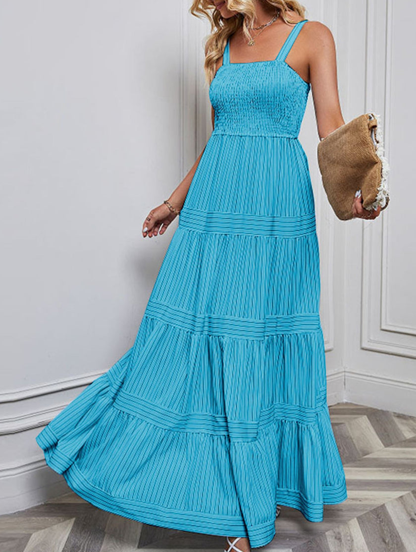 Blue retro striped maxi dress by FJØRNA featuring a flowing silhouette and classic pattern, perfect for casual or summer wear.