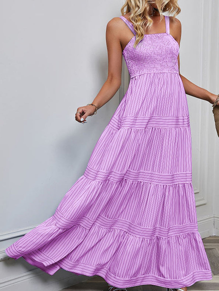 Purple retro striped maxi dress by FJØRNA featuring a flowing design and bold pattern, perfect for casual or summer wear.