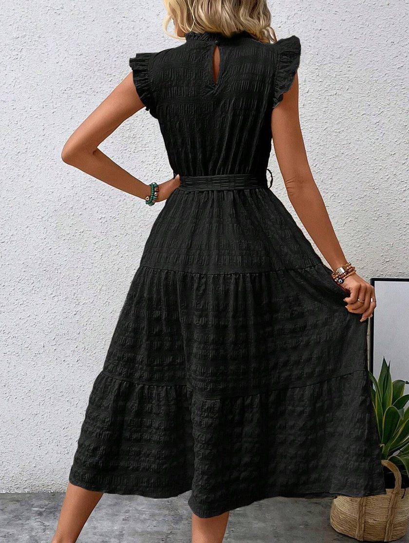 Black FJØRNA ruffled flutter sleeve tie textured dress with a stylish silhouette and intricate fabric details.