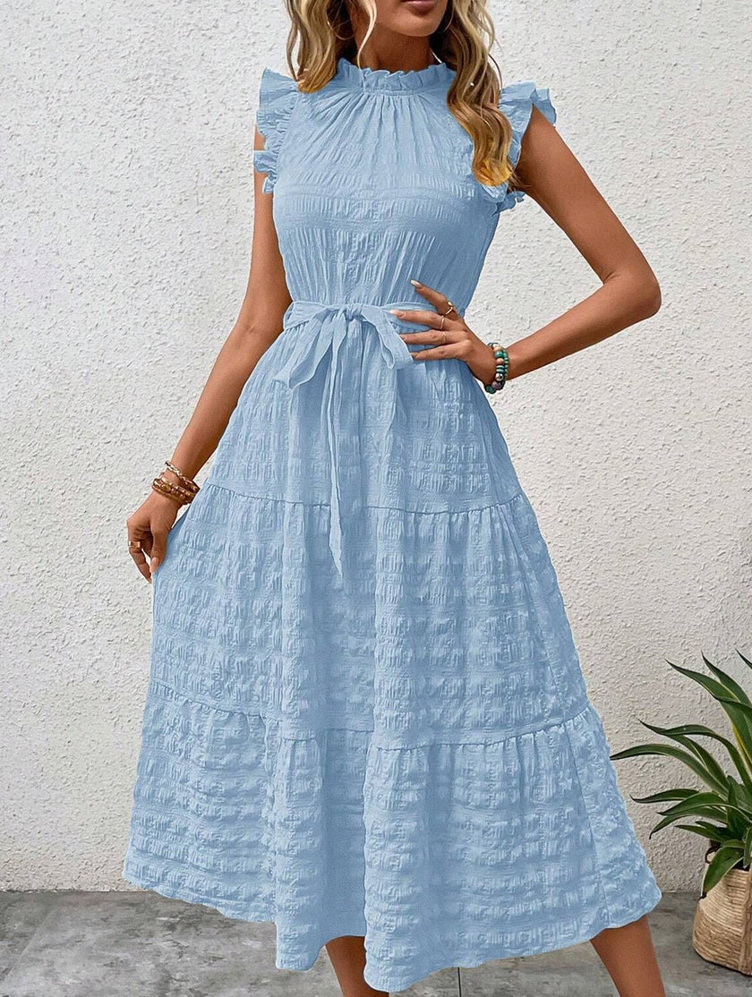 Light blue FJØRNA ruffled flutter sleeve tie textured dress with a feminine silhouette and intricate fabric details.