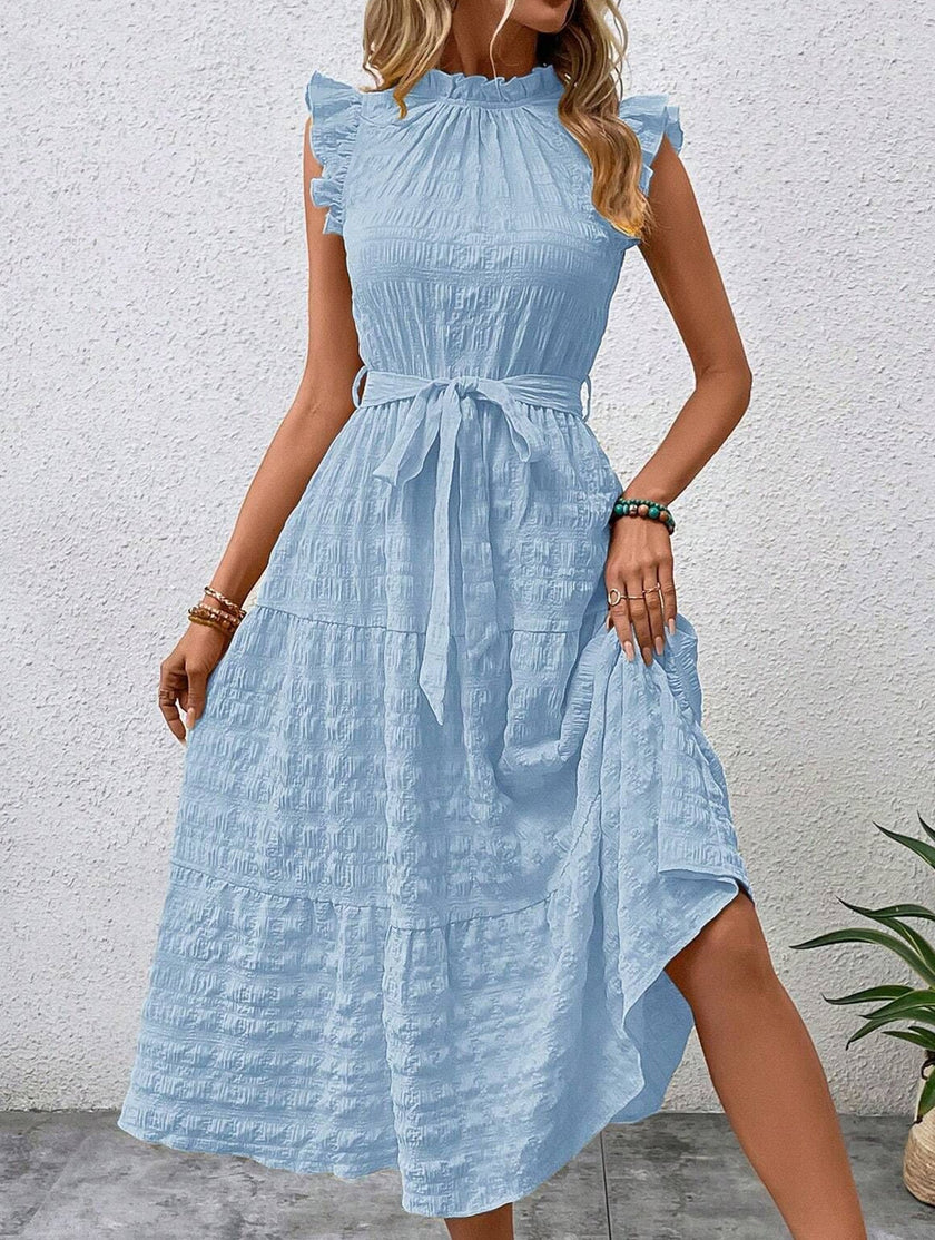 Light blue FJØRNA ruffled flutter sleeve tie textured dress with a flowy silhouette and intricate fabric details.