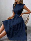 White FJØRNA ruffled flutter sleeve tie textured dress displayed on a model featuring a stylish, feminine design.