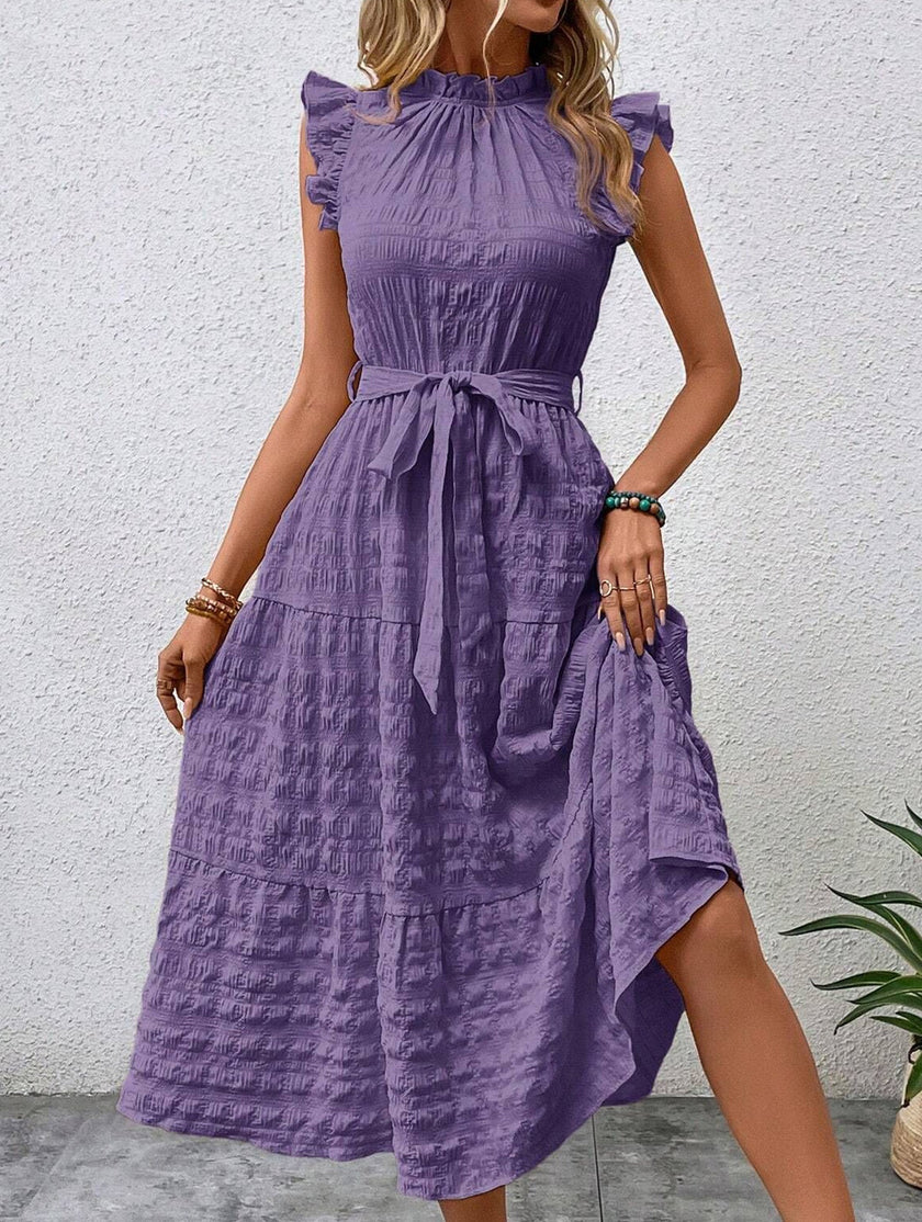 Purple FJØRNA ruffled flutter sleeve tie textured dress with flowy fabric and detailed design, perfect for elegant occasions.