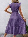 Purple FJØRNA ruffled flutter sleeve tie-textured dress with a flowy silhouette and intricate fabric details.