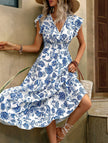 FJØRNA white V-neck dress with fashionable print, stylish and elegant dress for women, showcasing the dress's design.