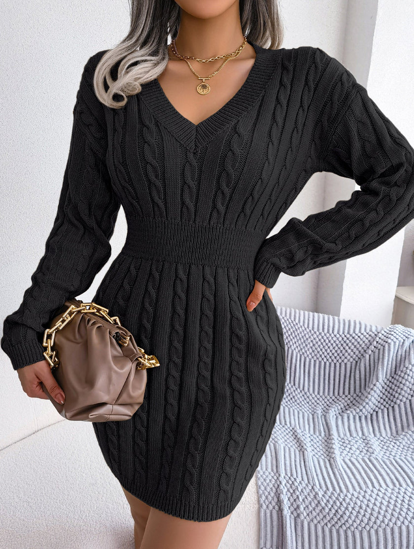 Black cable-knit waist-hugging hip dress by FJØRNA, showcasing its fitted silhouette and stylish knit design.
