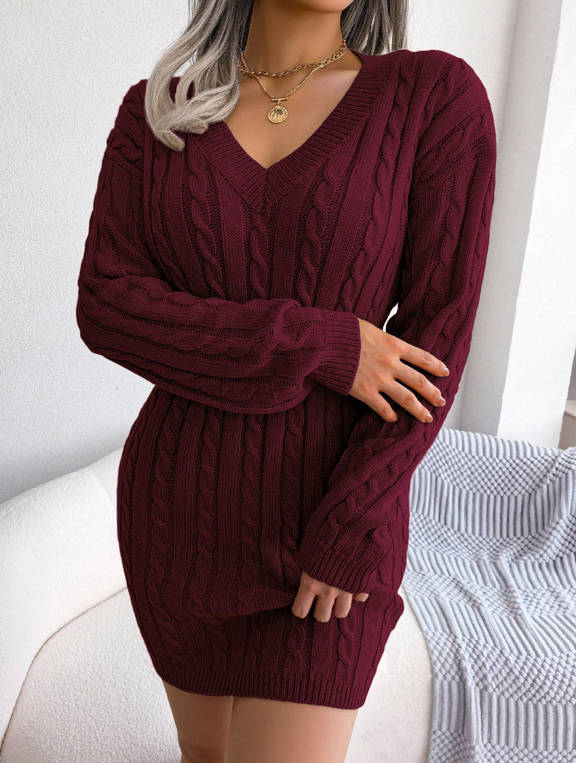 White cable-knit waist-hugging hip dress by FJØRNA, showing a fitted, stylish knit dress with long sleeves and a high neckline.