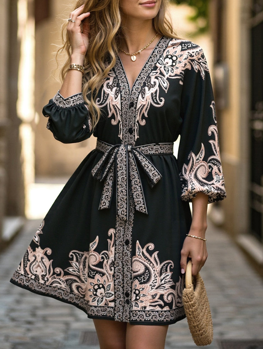 FJØRNA printed white V-neck three-quarter sleeve dress with tie waist, stylish and comfortable for casual or semi-formal wear.