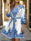 FJØRNA printed white V-neck dress with three-quarter sleeves and tie waist, featuring a stylish and comfortable design.