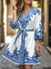 FJØRNA printed white V-neck dress with three-quarter sleeves and tie waist, featuring a stylish and comfortable design.