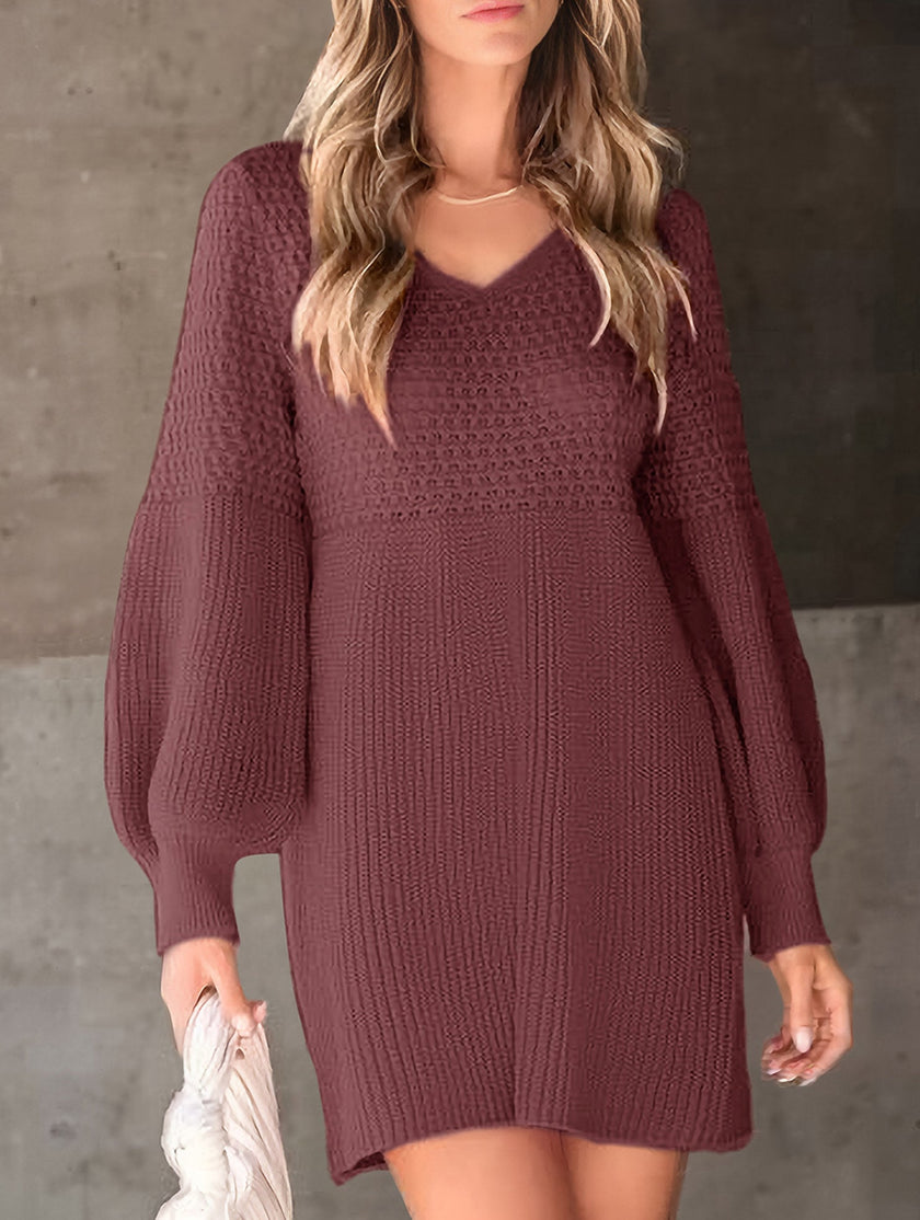 White V-neck puff sleeve knitted sweater dress by FJØRNA, featuring a solid color design and cozy knit fabric.