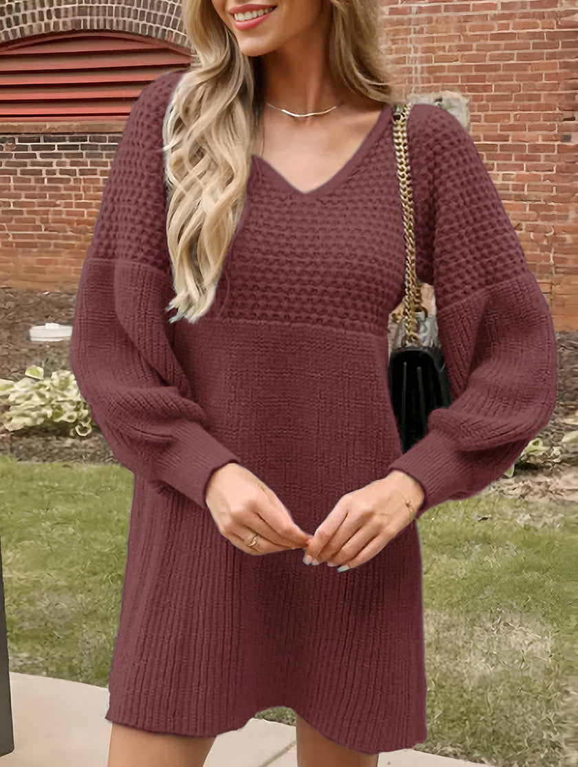 White V-neck knitted sweater dress with puff sleeves by FJØRNA, featuring a solid color design and cozy, stylish fit.