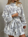 FJØRNA long-sleeved tie-print white dress with a stylish design, perfect for fashionable occasions.