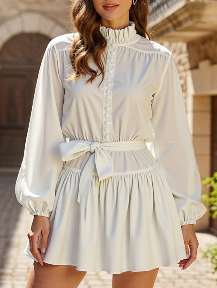 White FJØRNA long-sleeved tie-print dress with a stylish, flowing design perfect for fashionable occasions.