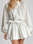 FJØRNA long-sleeved white tie-print dress with a stylish design, perfect for fashionable occasions.