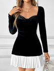 Black and white heart-shaped dress by FJØRNA, featuring a classic design with a fitted silhouette and elegant detailing.
