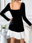 Black and white heart-shaped dress by FJØRNA, made of elegant fabric, displayed on a hanger against a neutral background.