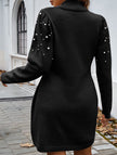 FJØRNA solid black long-sleeved sweater dress displayed on a hanger, showcasing its soft knit fabric and classic design.