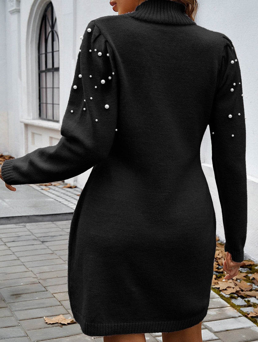 FJØRNA solid black long-sleeved sweater dress displayed on a hanger, showcasing its soft knit fabric and classic design.
