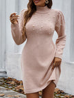 White FJØRNA long-sleeved sweater dress displayed on a hanger, showcasing its solid color and cozy knit fabric.