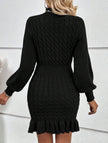Black cable knit waist-cinching sweater dress by FJØRNA, featuring a fitted silhouette and stylish design.
