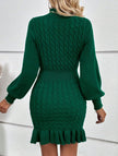 Green FJØRNA cable knit waist-cinching sweater dress, stylish and fitted, showcasing its cozy texture and flattering silhouette.