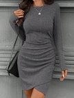 FJØRNA white knitted slim-fit long-sleeve dress displayed on a hanger, showcasing its stylish, fitted design and soft fabric.
