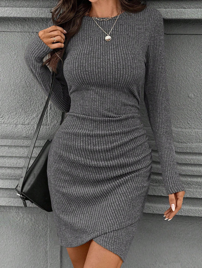 FJØRNA white knitted slim-fit long-sleeve dress displayed on a hanger, showcasing its stylish, fitted design and soft fabric.