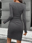 FJØRNA white knitted slim-fit long-sleeved dress displayed on a mannequin, showcasing its stylish design and fitted silhouette.