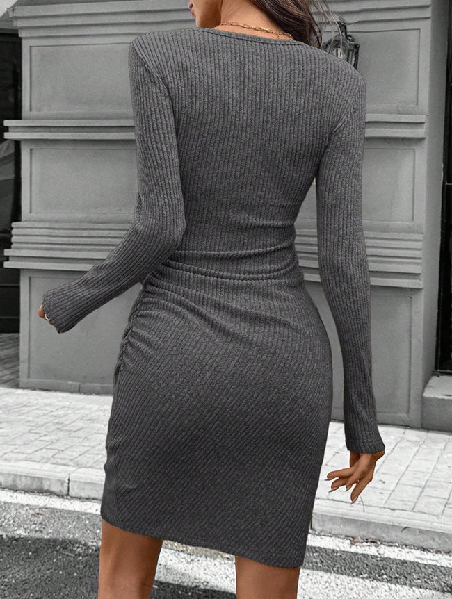 FJØRNA white knitted slim-fit long-sleeved dress displayed on a mannequin, showcasing its stylish design and fitted silhouette.