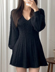 Black FJØRNA retro cable knit V-neck fitted dress, showcasing its textured knit fabric and classic silhouette.