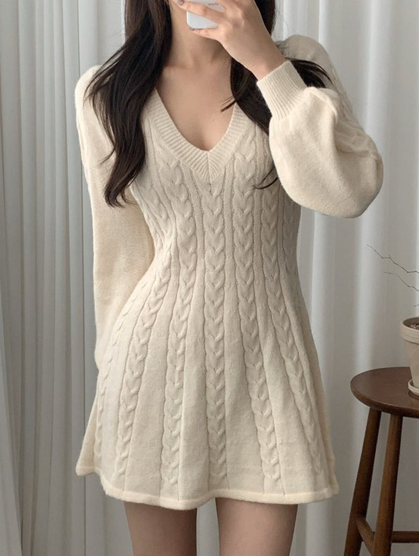 White retro cable knit V-neck fitted dress by FJØRNA, showcasing a stylish, textured knit with a fitted silhouette.