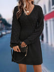 Black crochet V-neck A-line beach dress by FJØRNA, featuring a stylish design and lightweight fabric, perfect for summer beachwear.