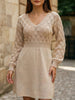 White crochet V-neck A-line beach dress by FJØRNA, featuring a relaxed fit and intricate knit details for summer wear.