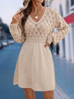 White crochet V-neck A-line beach dress by FJØRNA, featuring a flowing silhouette and intricate knit pattern.