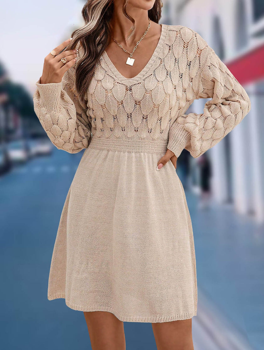 White crochet V-neck A-line beach dress by FJØRNA, featuring a flowing silhouette and intricate knit pattern.