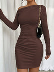 White FJØRNA one-shoulder long sleeve bodycon dress, shown in a stylish design on a model.