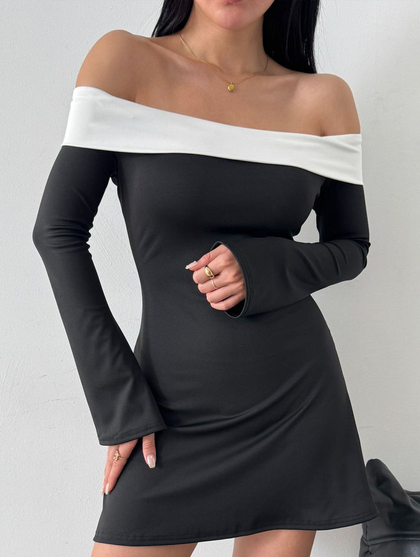 FJØRNA white off-shoulder bell sleeve dress with flowing fabric and fitted waist, perfect for elegant occasions.