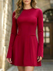 White backless long-sleeved slim-fit dress by FJØRNA, showing a sleek design with a fitted silhouette and elegant backless style.